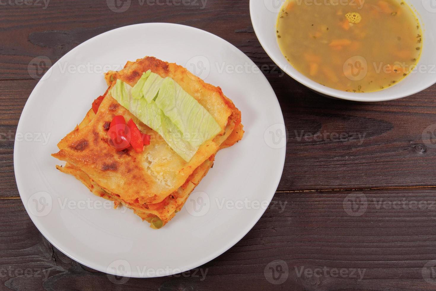 Lasagna with vegetables on a table photo