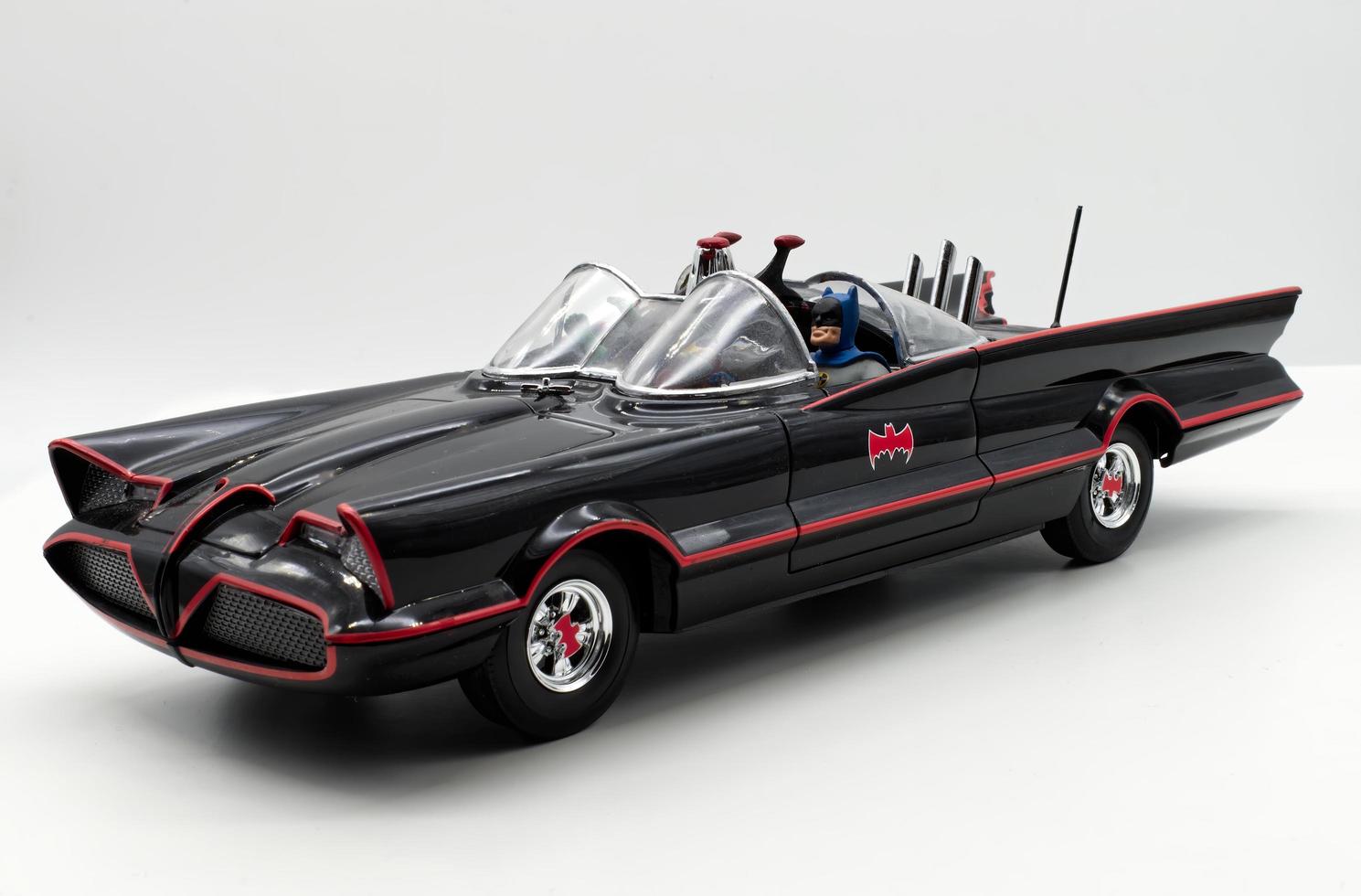 Bologna, Italy, 2022 - Classic Batman action figure inside the Batmobile on white background. Batman from DC comics. photo