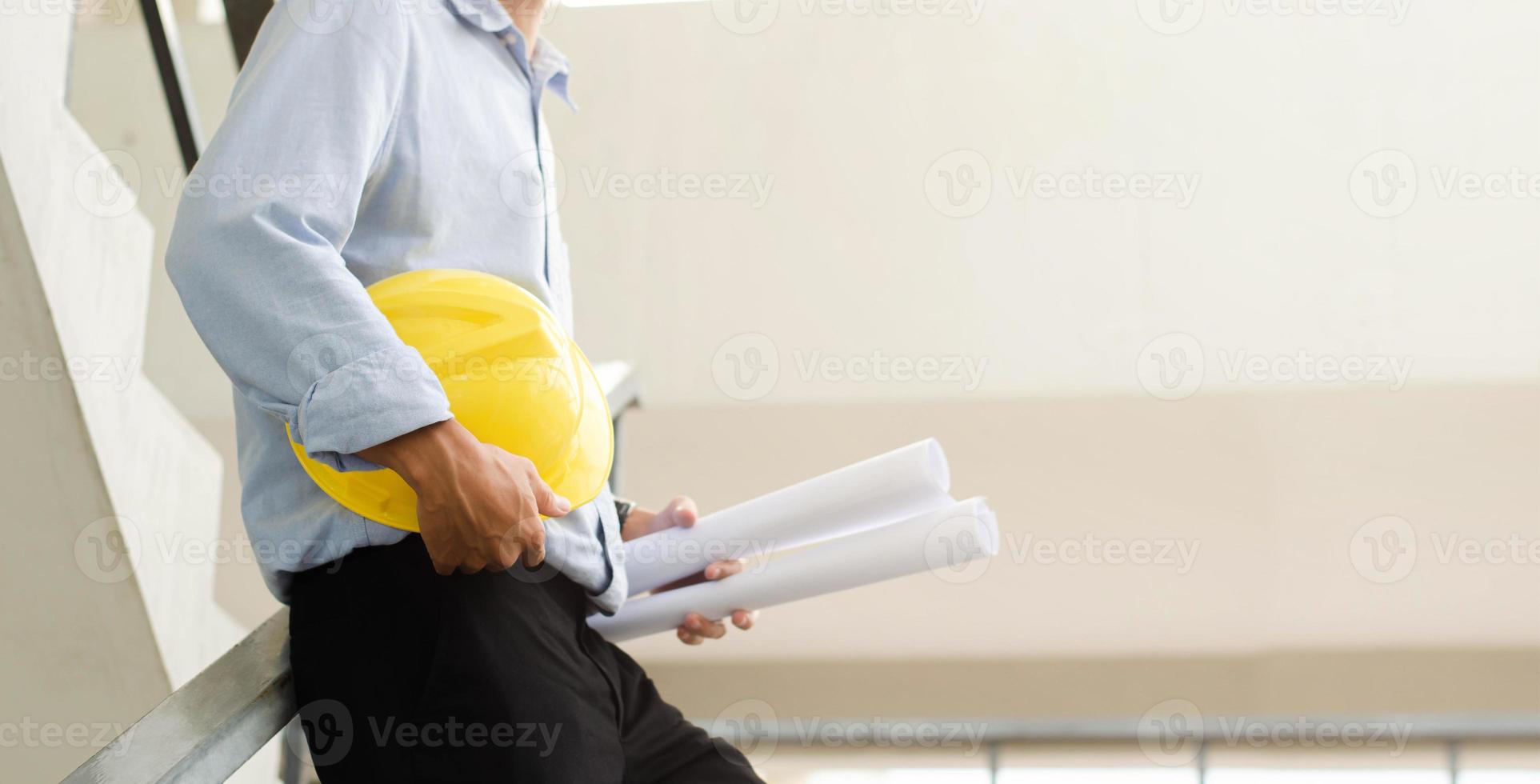 Close-up of engineers working on a construction site with blueprints, lighting, planning, engineering and architectural concepts. photo