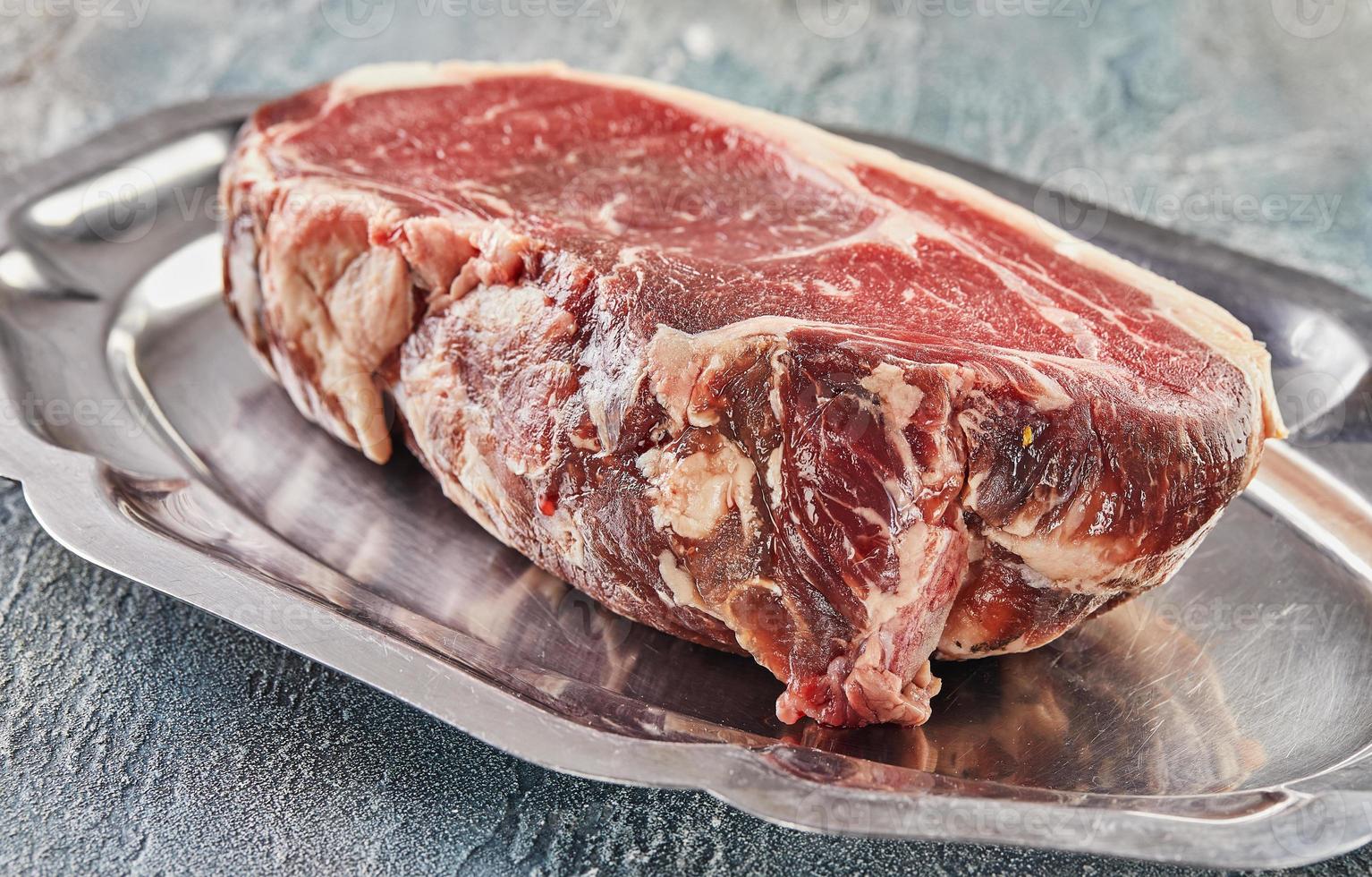 Fresh beef tenderloin on tray ready for cooking photo