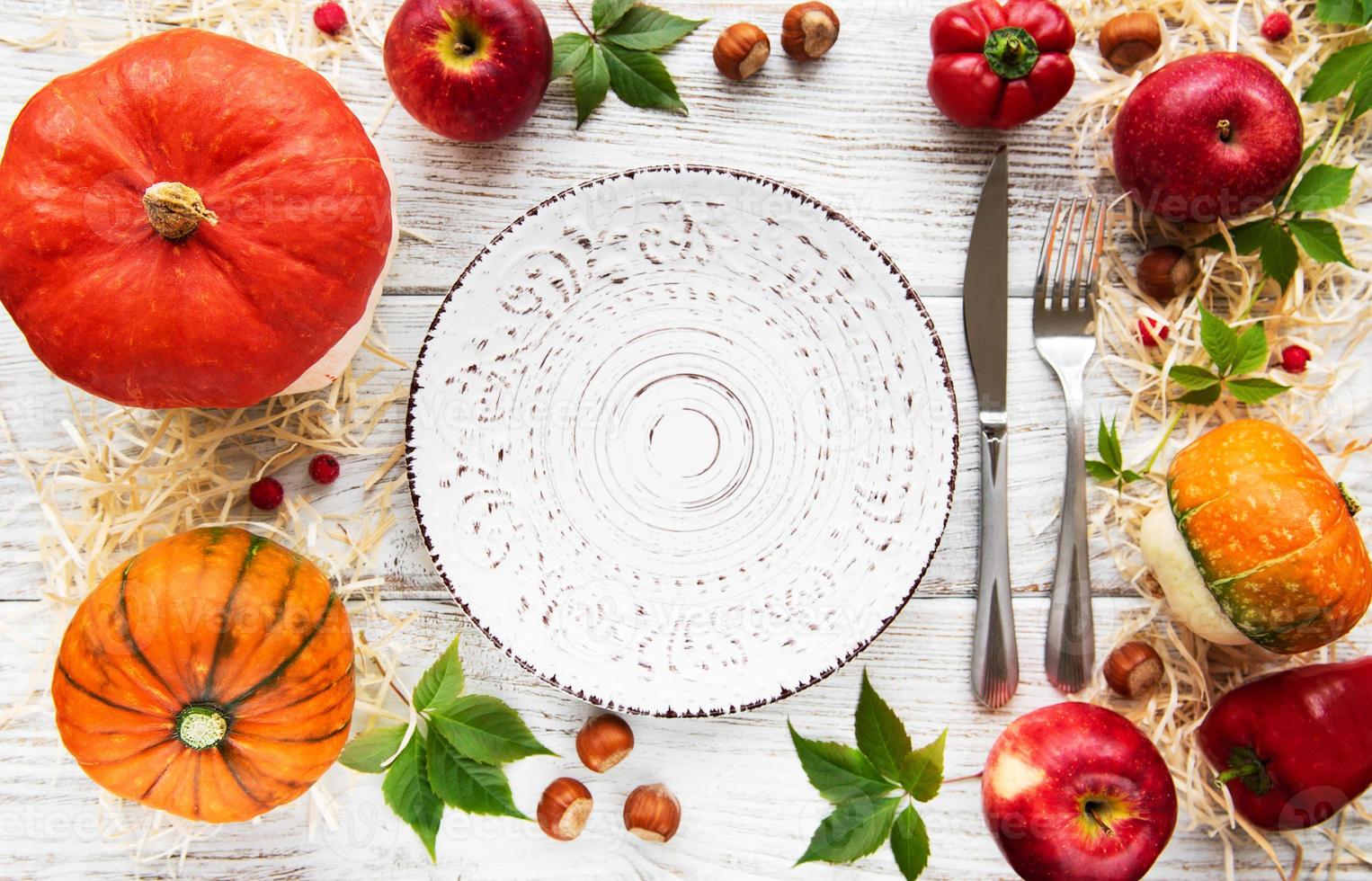 Empty plate and  colorful autumn pumpkins photo