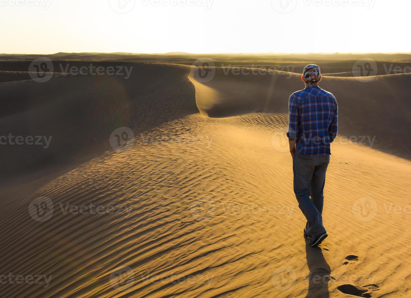 Walking man in the desert photo