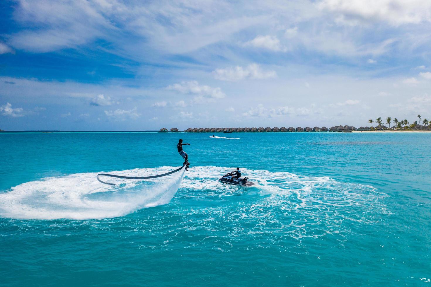 08.14.19, Iru Veli, Maldives islands, Aerial view of water extreme action sport, summer sea, close to luxury tropical resort . Fly board ocean lagoon, freedom fun summer recreational activity photo