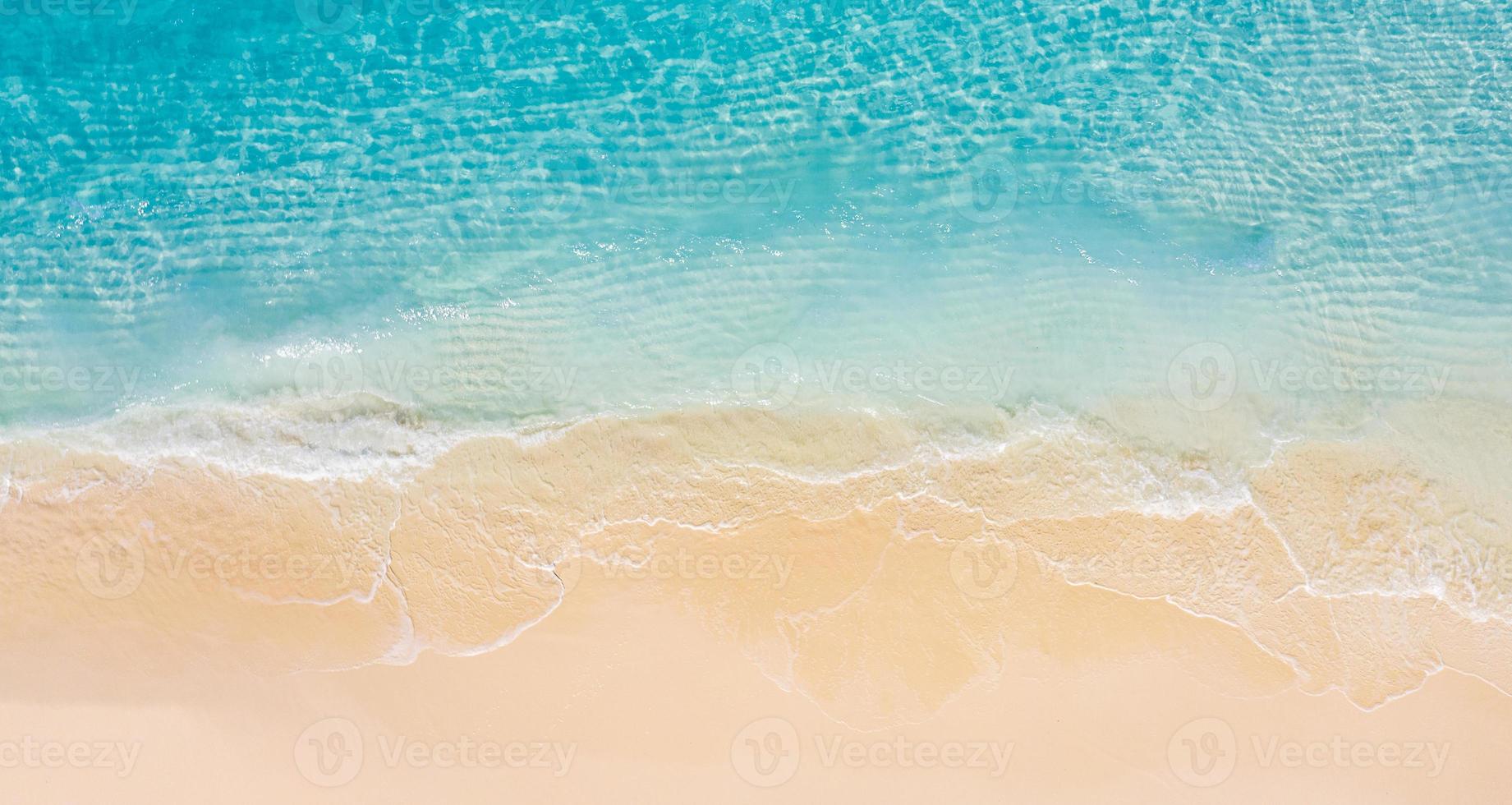 Relaxing aerial beach scene, summer vacation holiday template banner. Waves surf with amazing blue ocean lagoon, sea shore, coastline. Perfect aerial drone top view. Peaceful bright beach, seaside photo