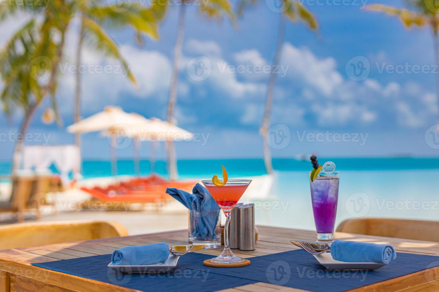 Luxury resort hotel poolside, outdoor restaurant on the beach, ocean and sky, tropical island cafe, tables, food. Summer vacation or holiday, family travel. Palm trees, infinity pool, cocktails, relax photo