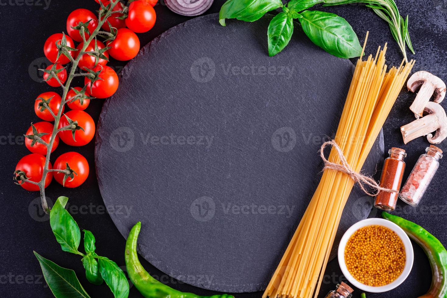 Pasta, cherry tomatoes, spices, herbs and other ingredients photo