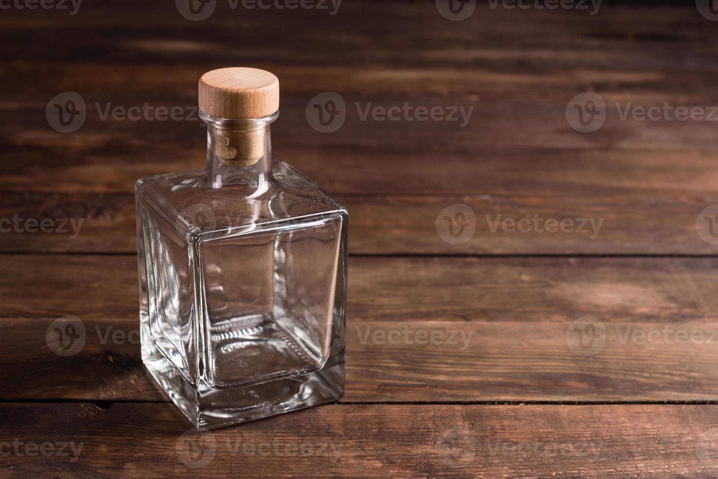 Transparent bottle with wooden cork photo