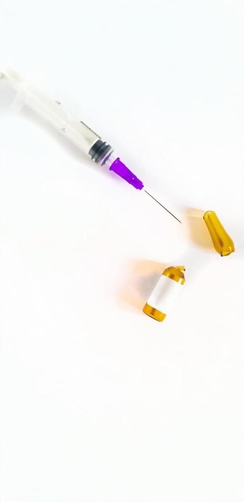 Syringe and one medicine ampoules on a white background. photo