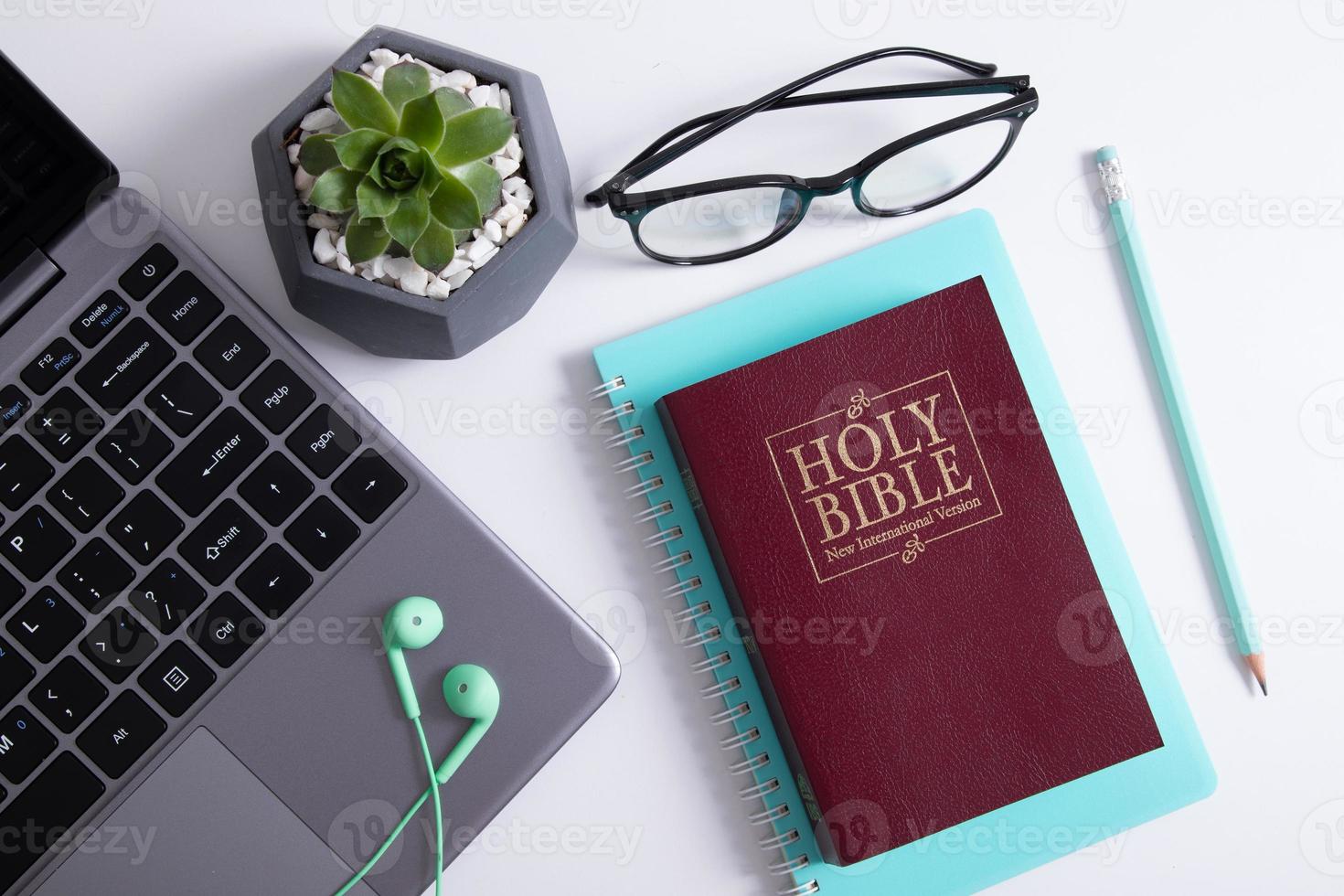 Bible and laptop on the work table with headphones. Bible Study Online photo