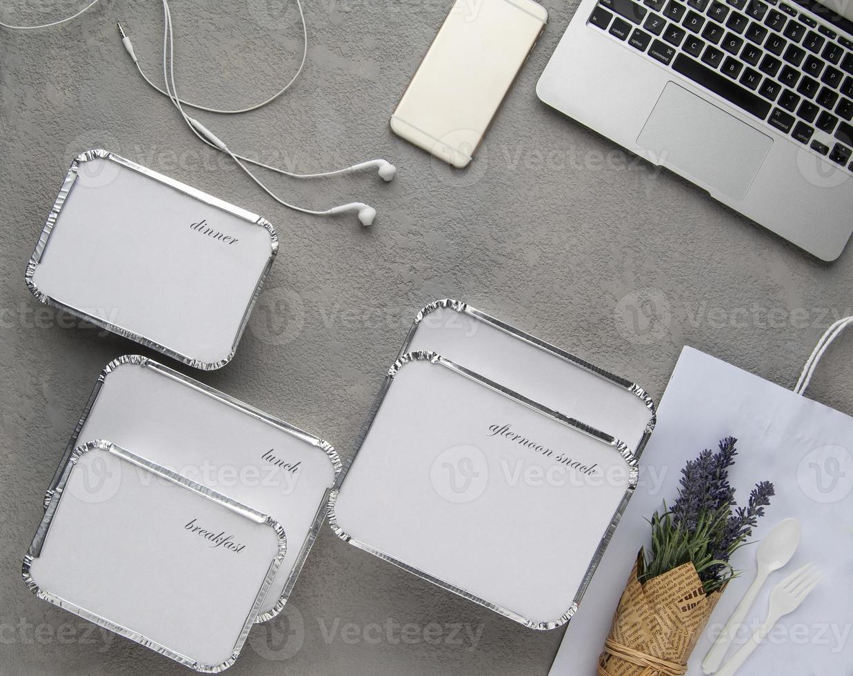 set of fast food with a laptop on a gray background. food for businessman and busy people photo