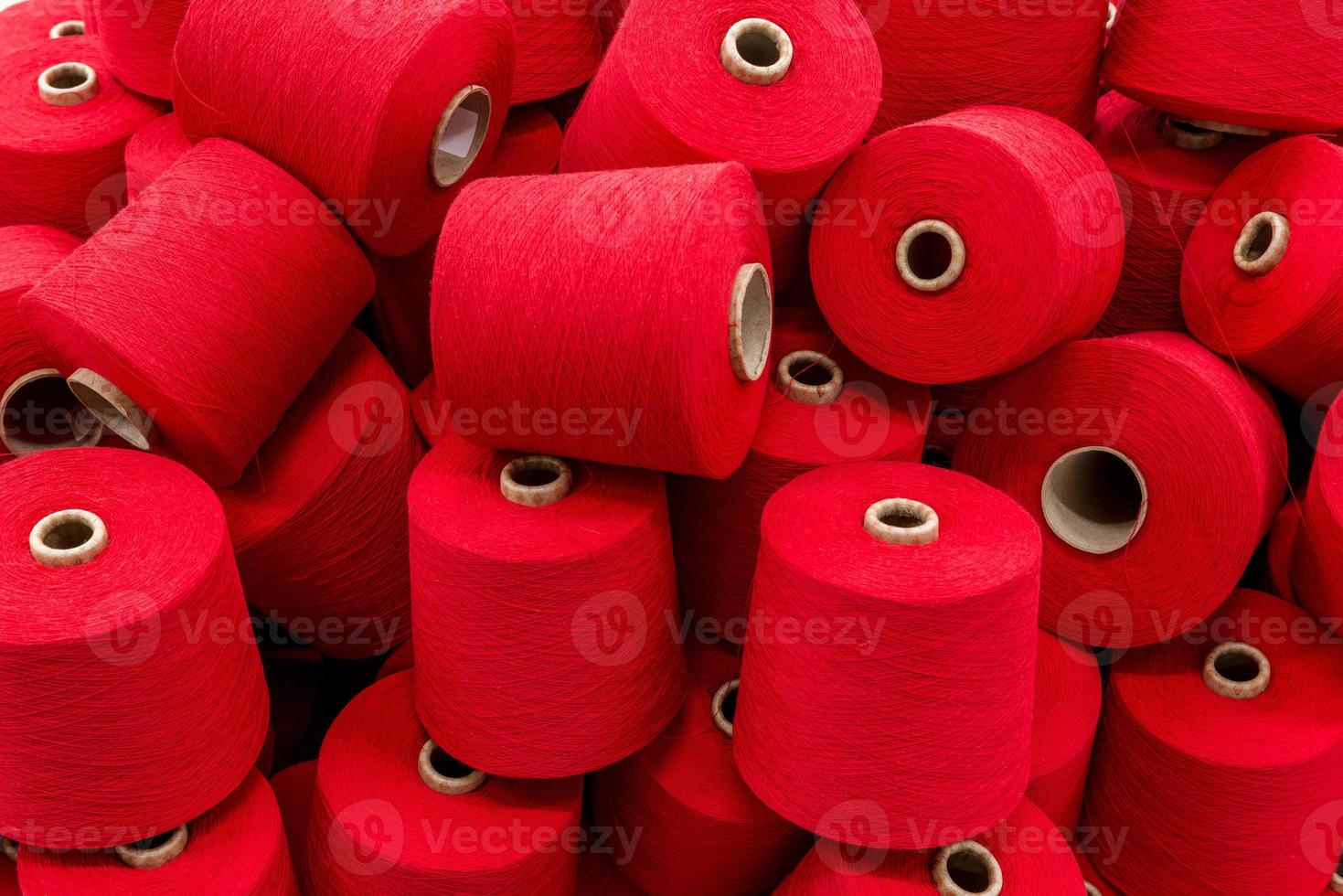 a large pile of spools of red thread. close-up photo