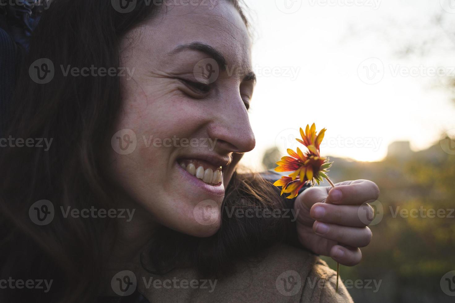 A child gives a flower to his mother photo