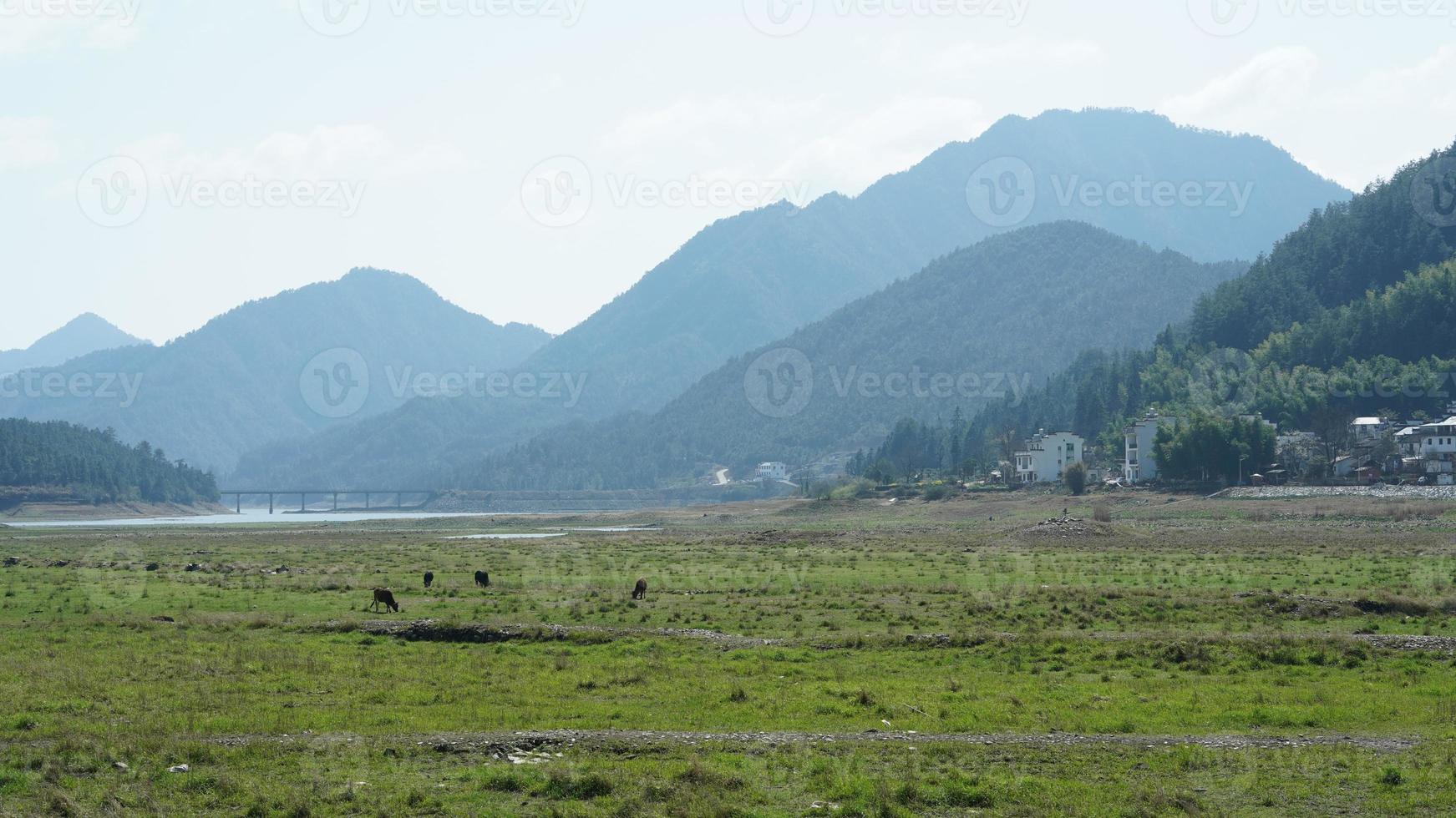 The  beautiful and old traditional Chinese village view with the mountains around it located in the countryside of the southern China photo