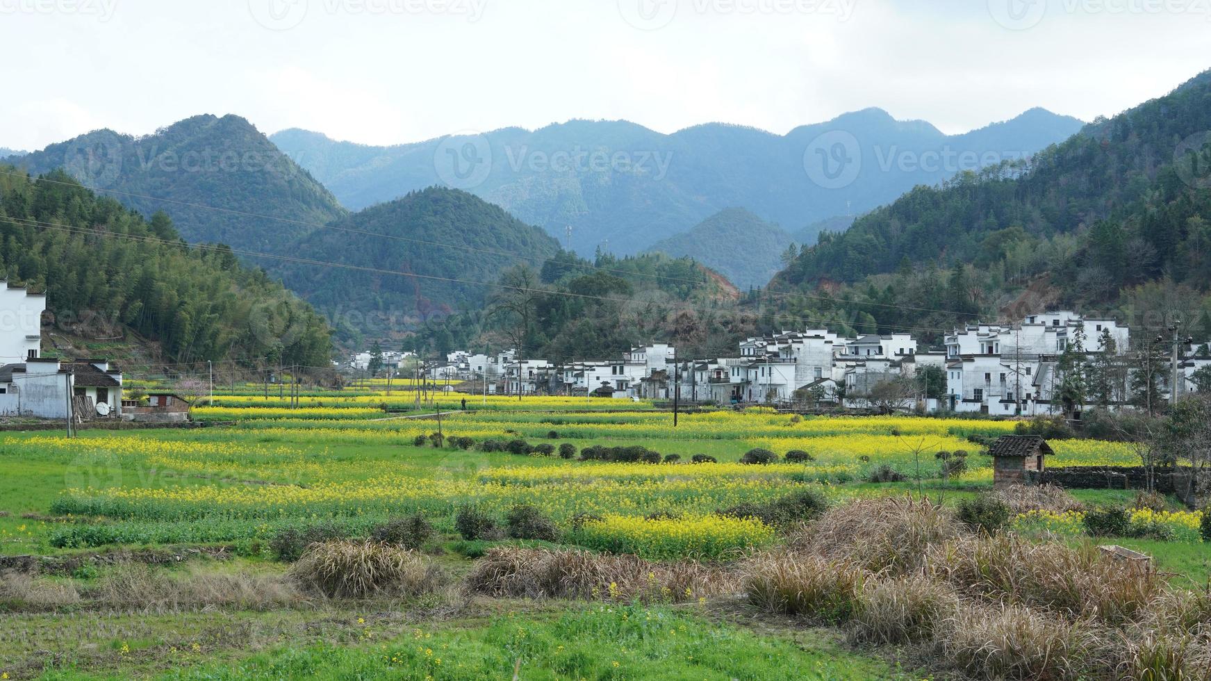 The  beautiful and old traditional Chinese village view with the mountains around it located in the countryside of the southern China photo