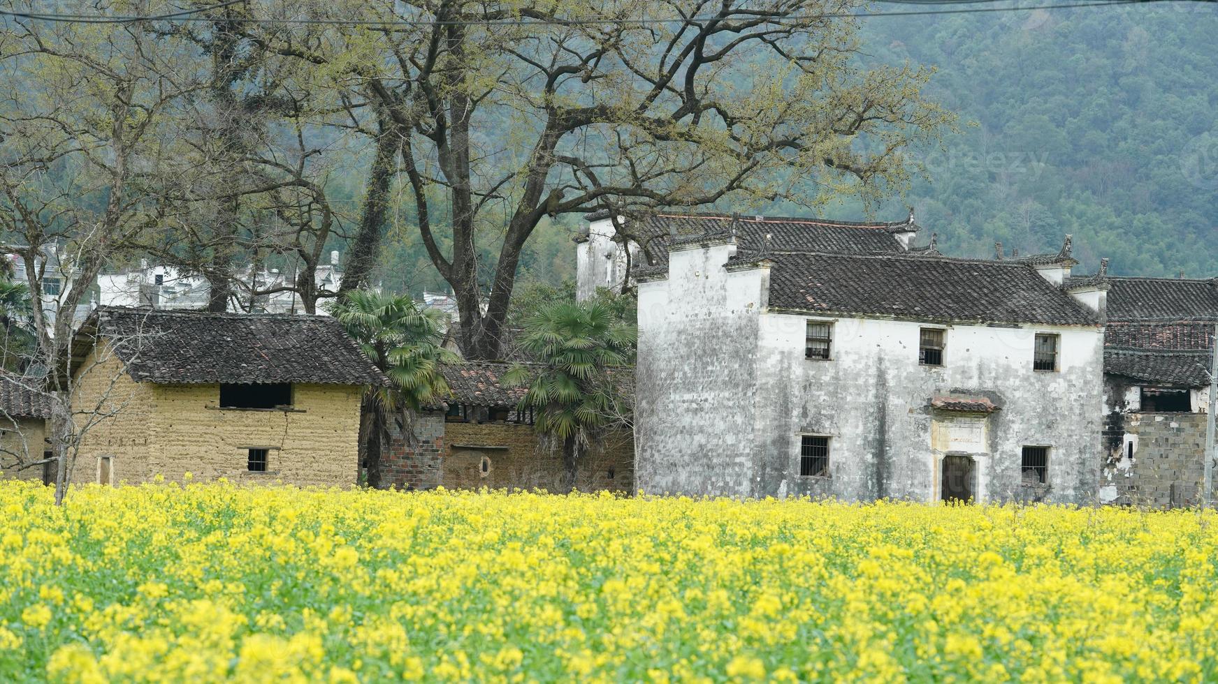 The  beautiful and old traditional Chinese village view with the mountains around it located in the countryside of the southern China photo