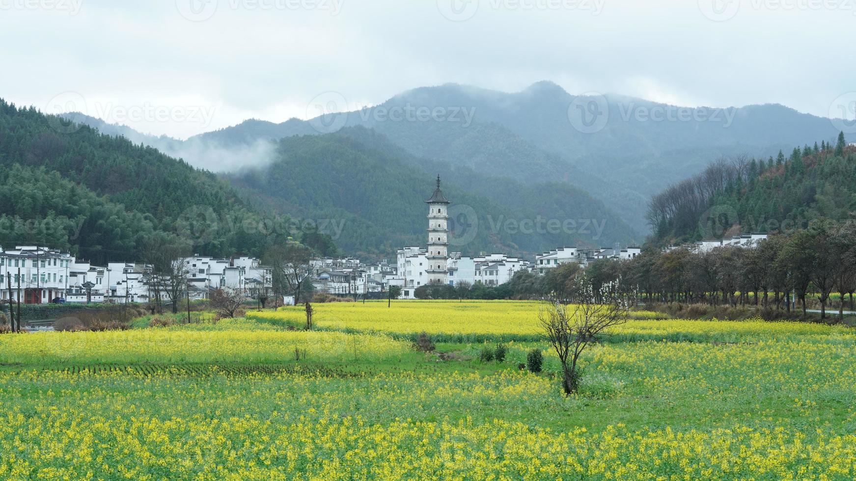 The  beautiful and old traditional Chinese village view with the mountains around it located in the countryside of the southern China photo