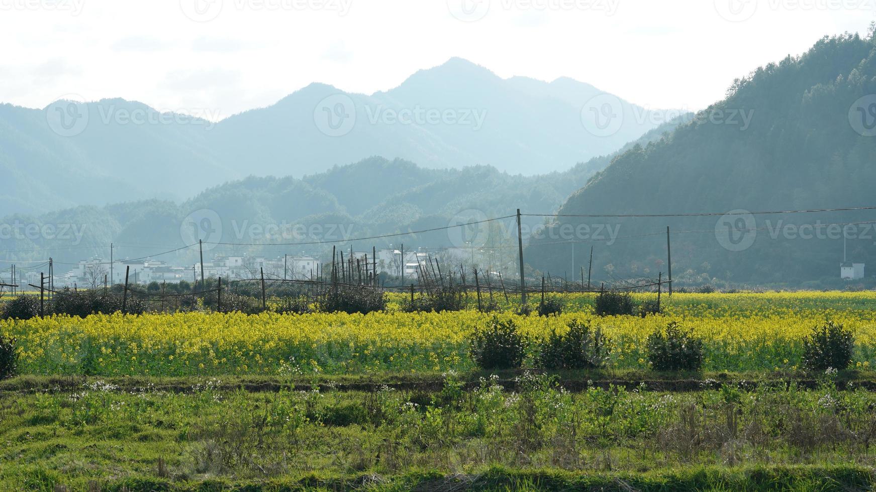 The  beautiful and old traditional Chinese village view with the mountains around it located in the countryside of the southern China photo