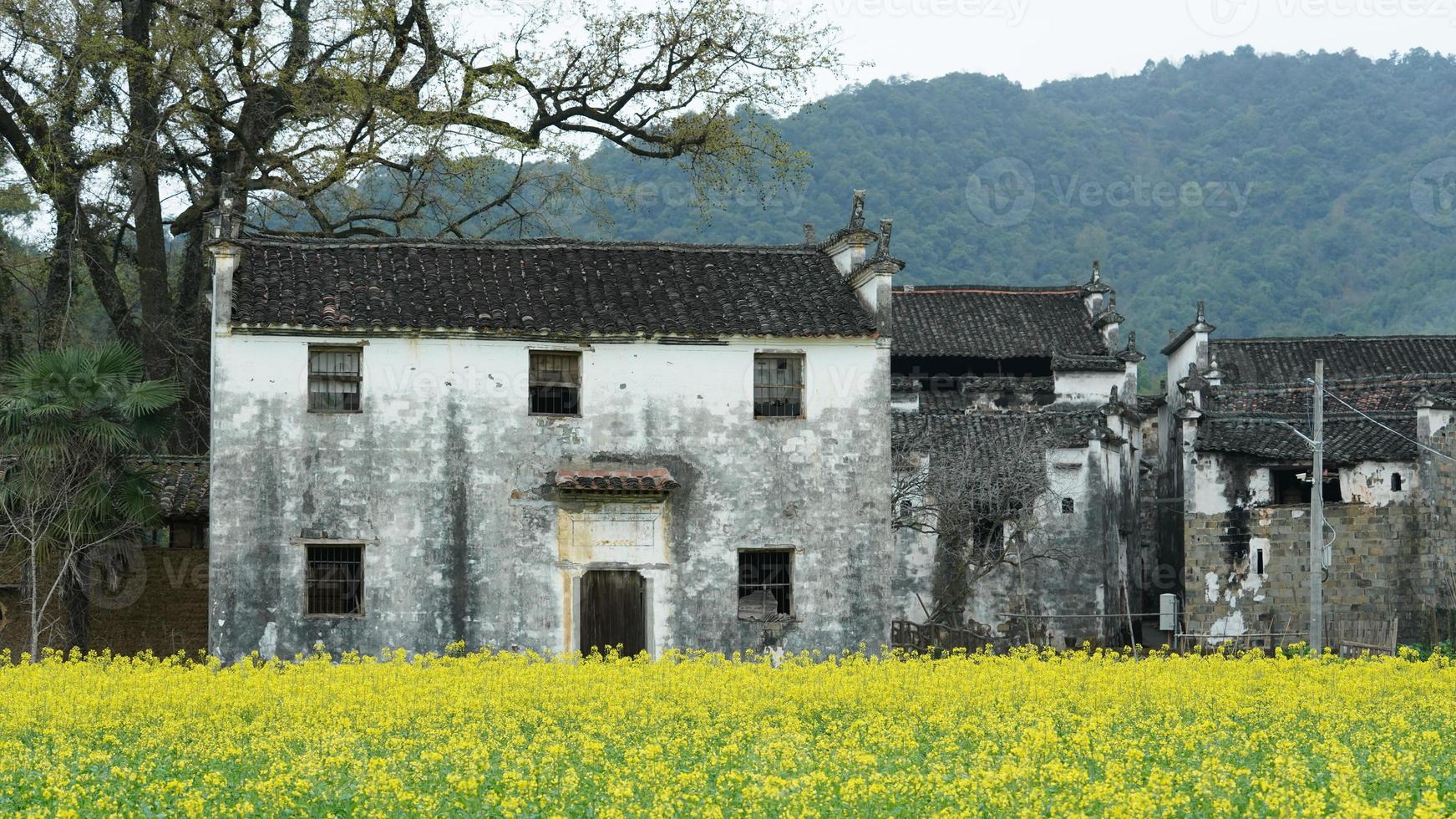 The  beautiful and old traditional Chinese village view with the mountains around it located in the countryside of the southern China photo