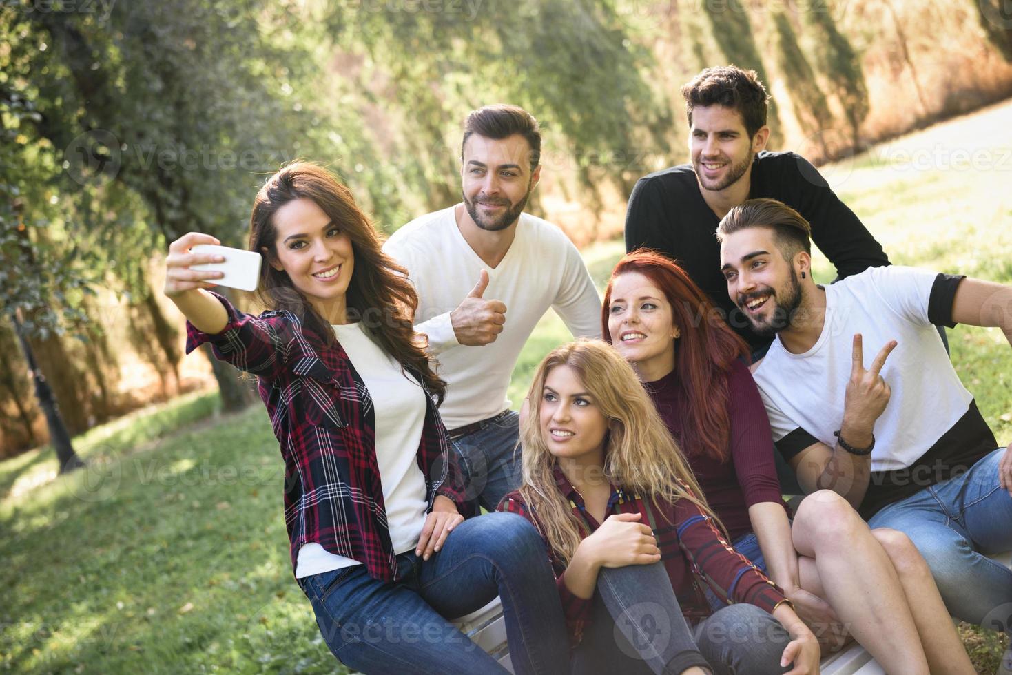 Group of friends taking selfie in urban background photo