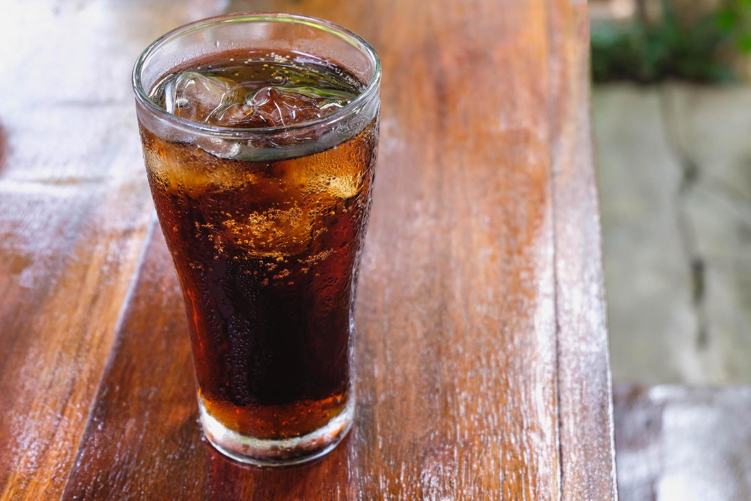 Glass of soft drinks and black soft drinks on the table photo