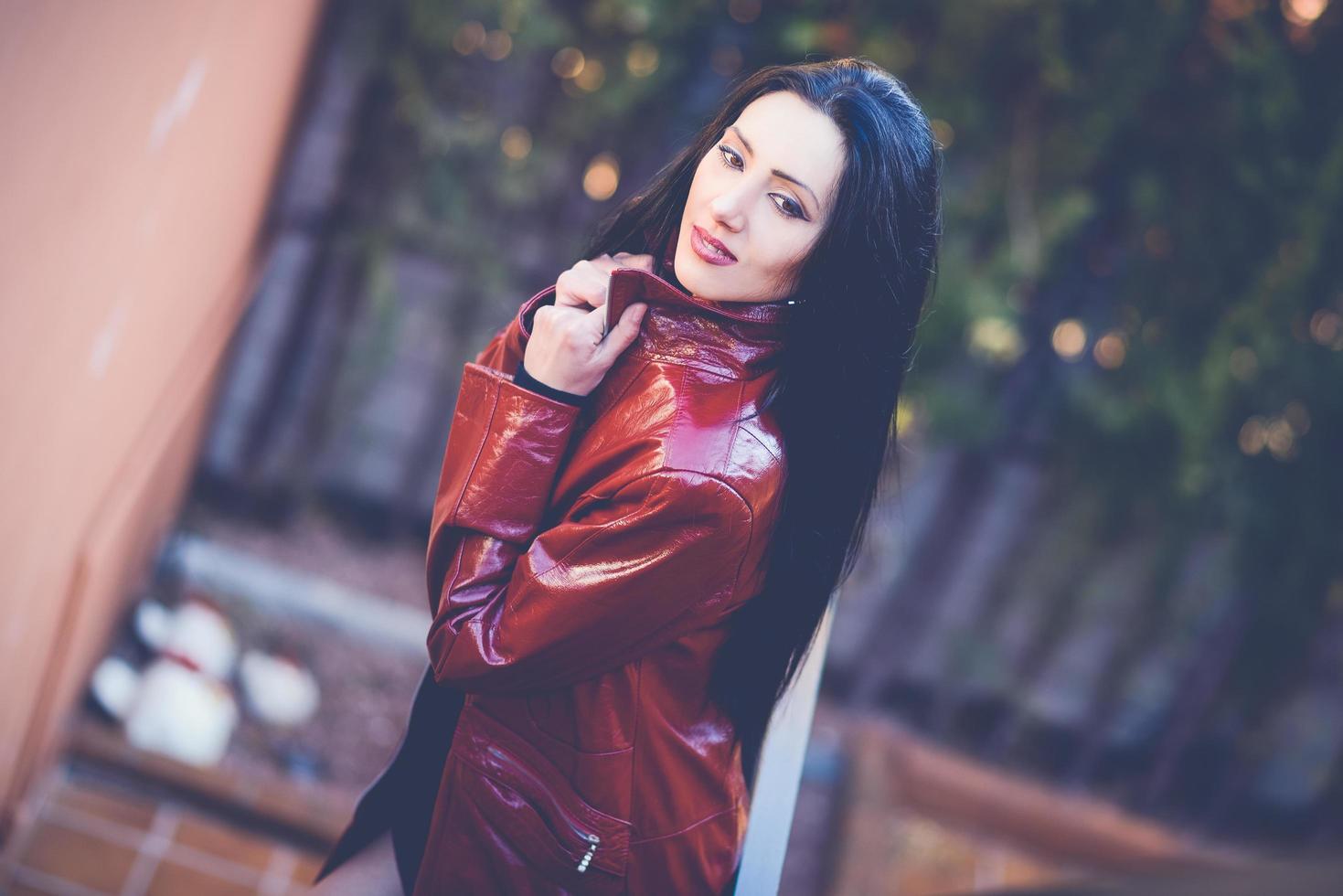 Beautiful woman with long hair in urban background photo