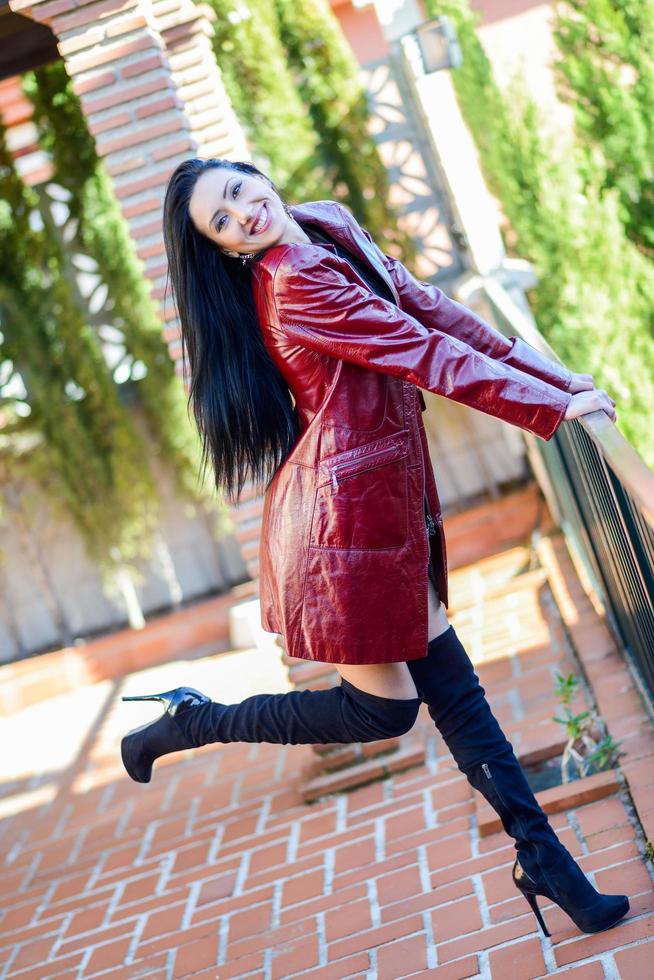 Beautiful woman with long hair in urban background photo