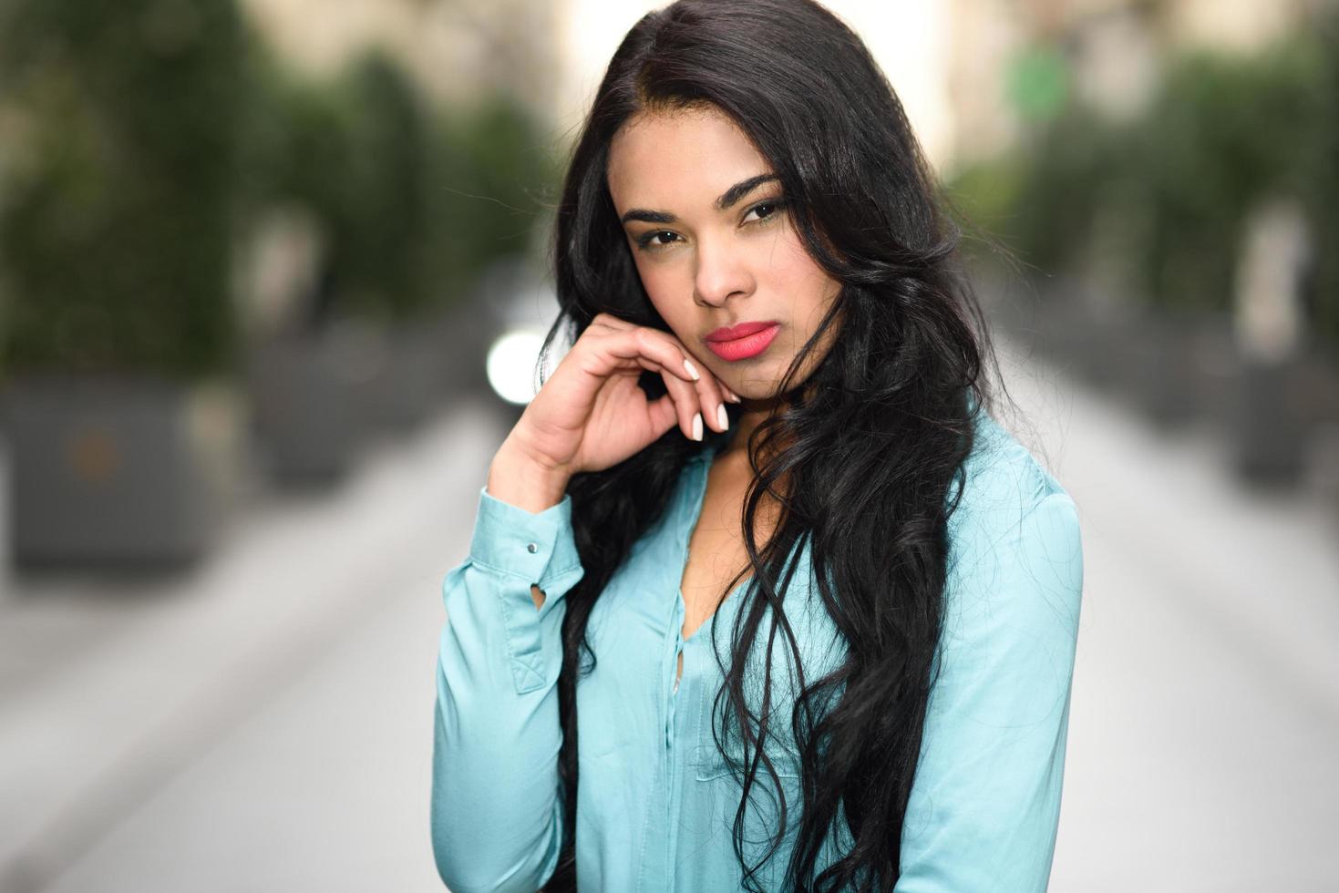 Hispanic young woman wearing casual clothes in urban background photo