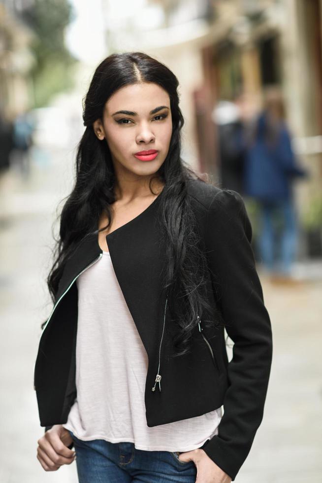 Hispanic young woman wearing casual clothes in urban background photo