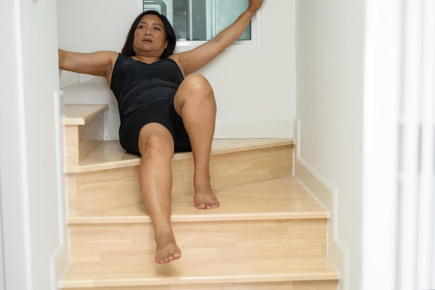 Asian middle-aged lady woman patient fall down the stairs because slippery surfaces photo