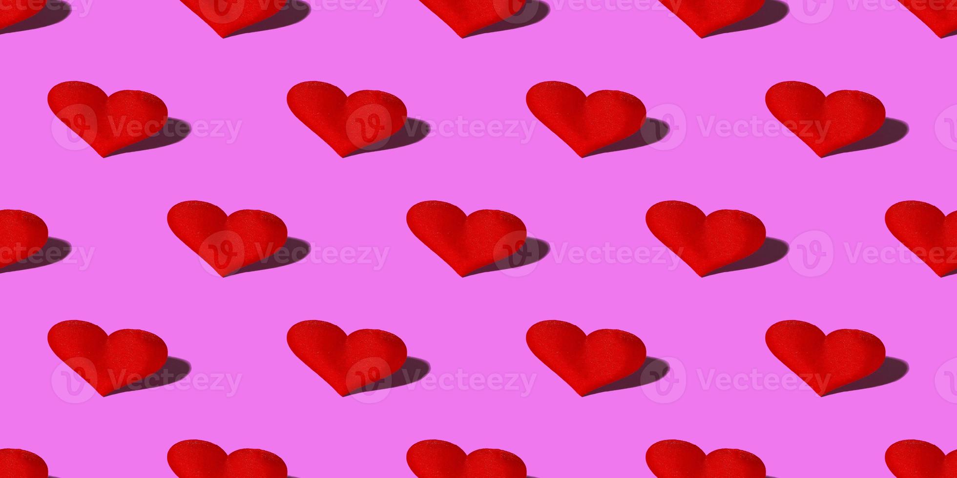 Red heart with a hard shadow on a pink background. Seamless patterns. Celebrating Valentine's Day copy space. Banner photo
