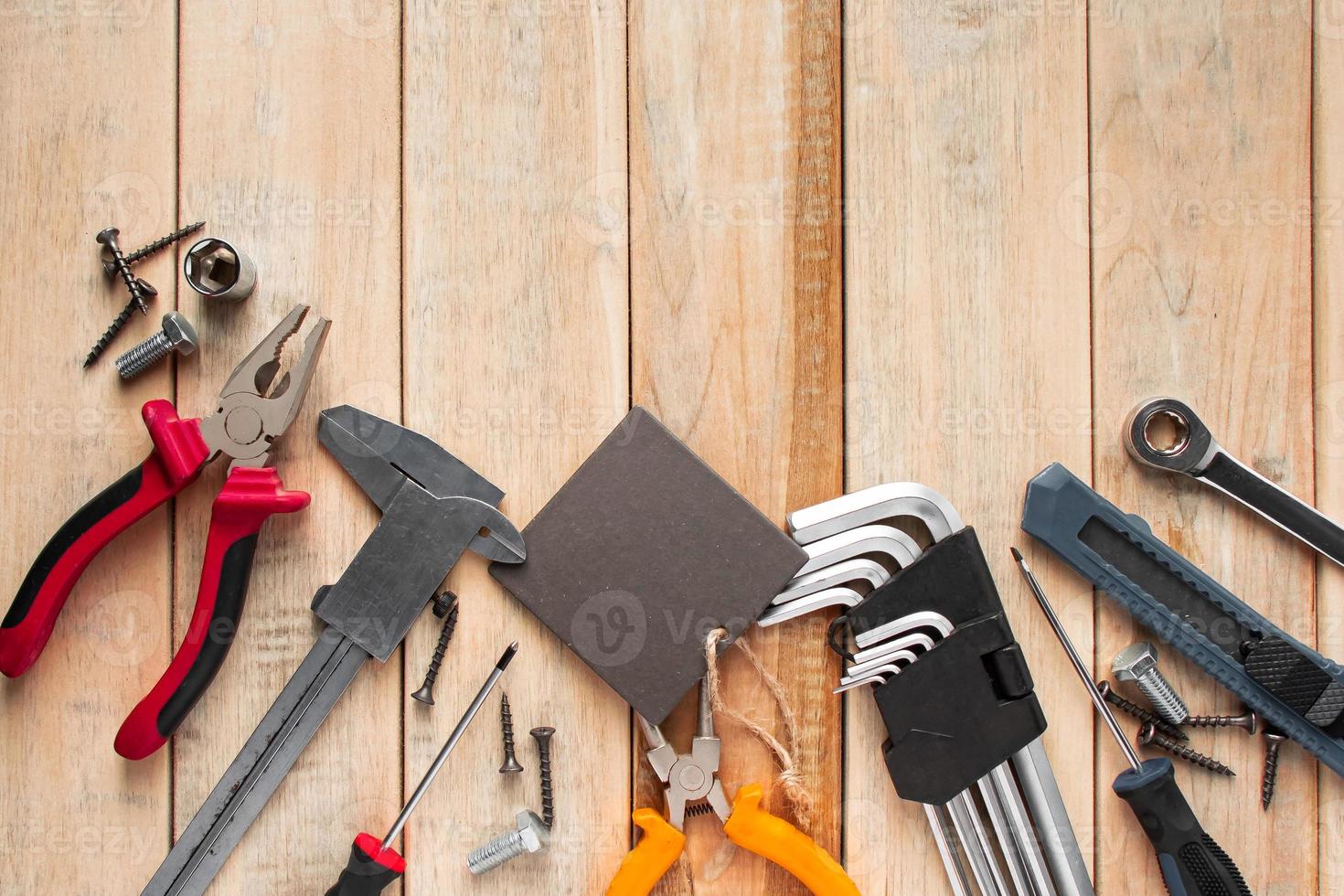 Set of work tools on a wooden background. photo