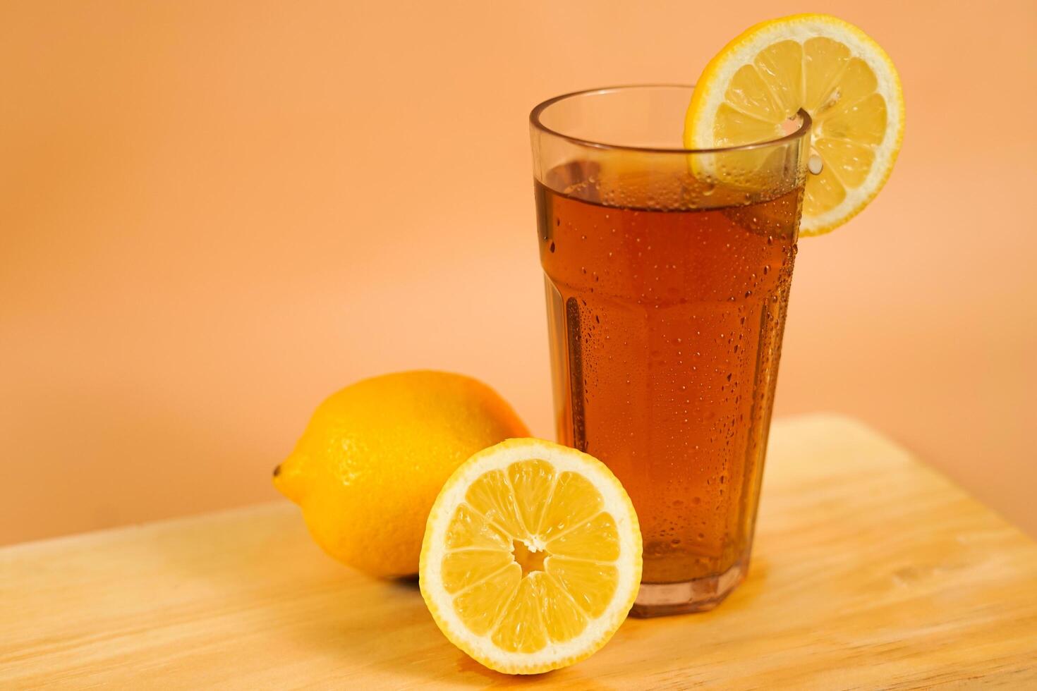 A glass of tea decorated with sliced oranges around photo