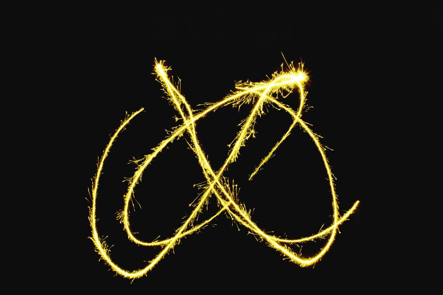 abstract curve gold yellow sparkler overlays texture elegant surface pattern on black. photo