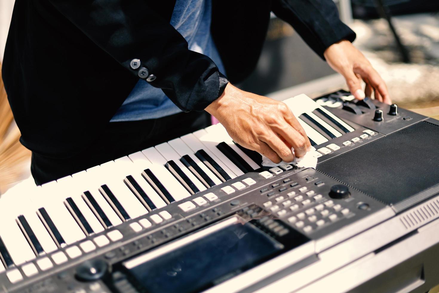 Part of a man's hand playing the piano photo