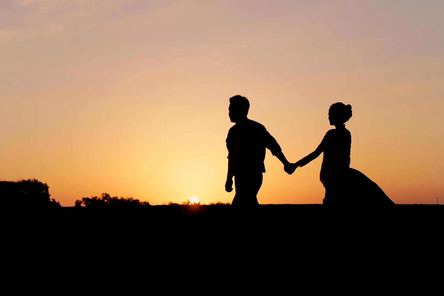 silueta, de, un, romántico, pareja joven, en la playa foto