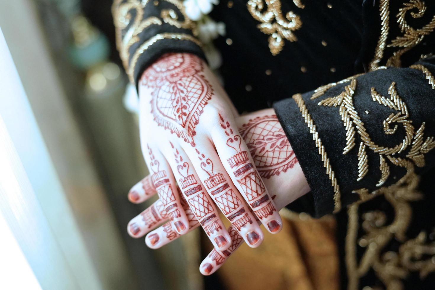 Bride henna carved beautiful and unique at bride's hand photo