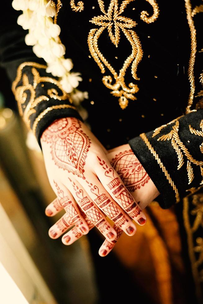 Bride henna carved beautiful and unique at bride's hand photo