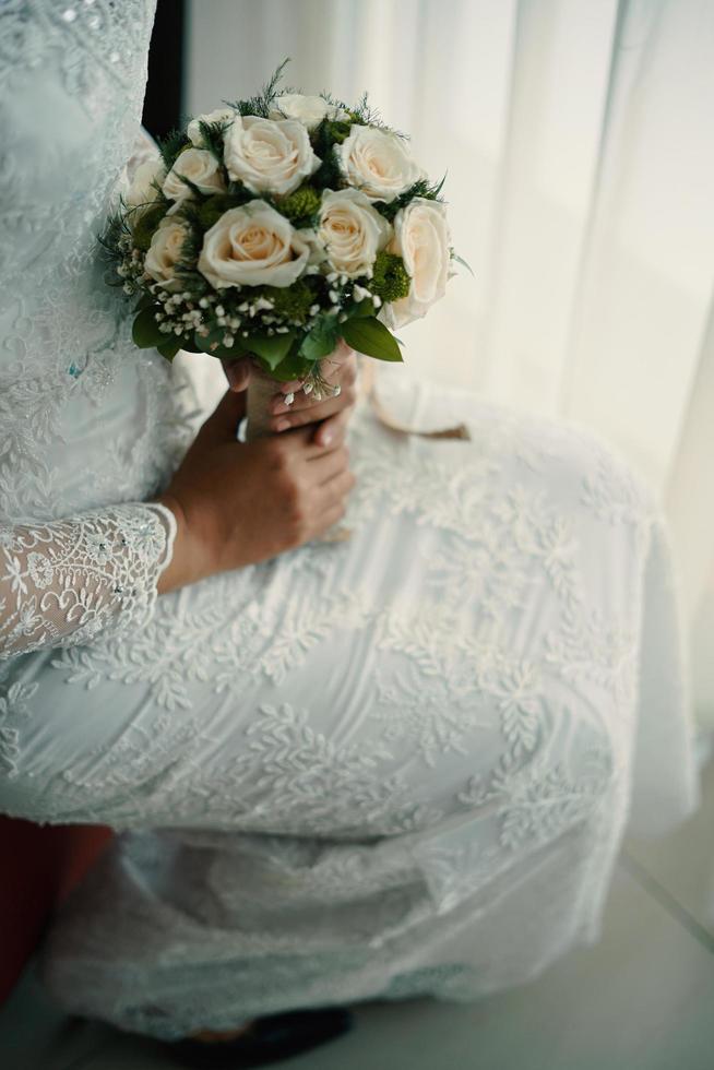 Wedding bouquet of flowers in brides' hands photo