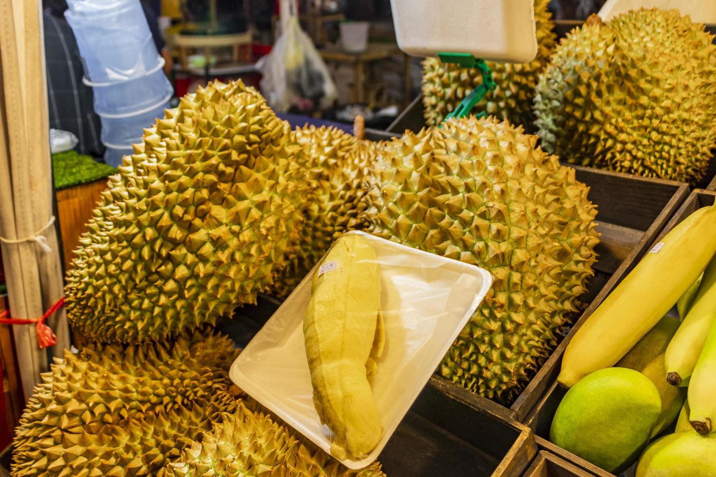 Smelly fresh durian fruit Thai night market street food, Bangkok. photo