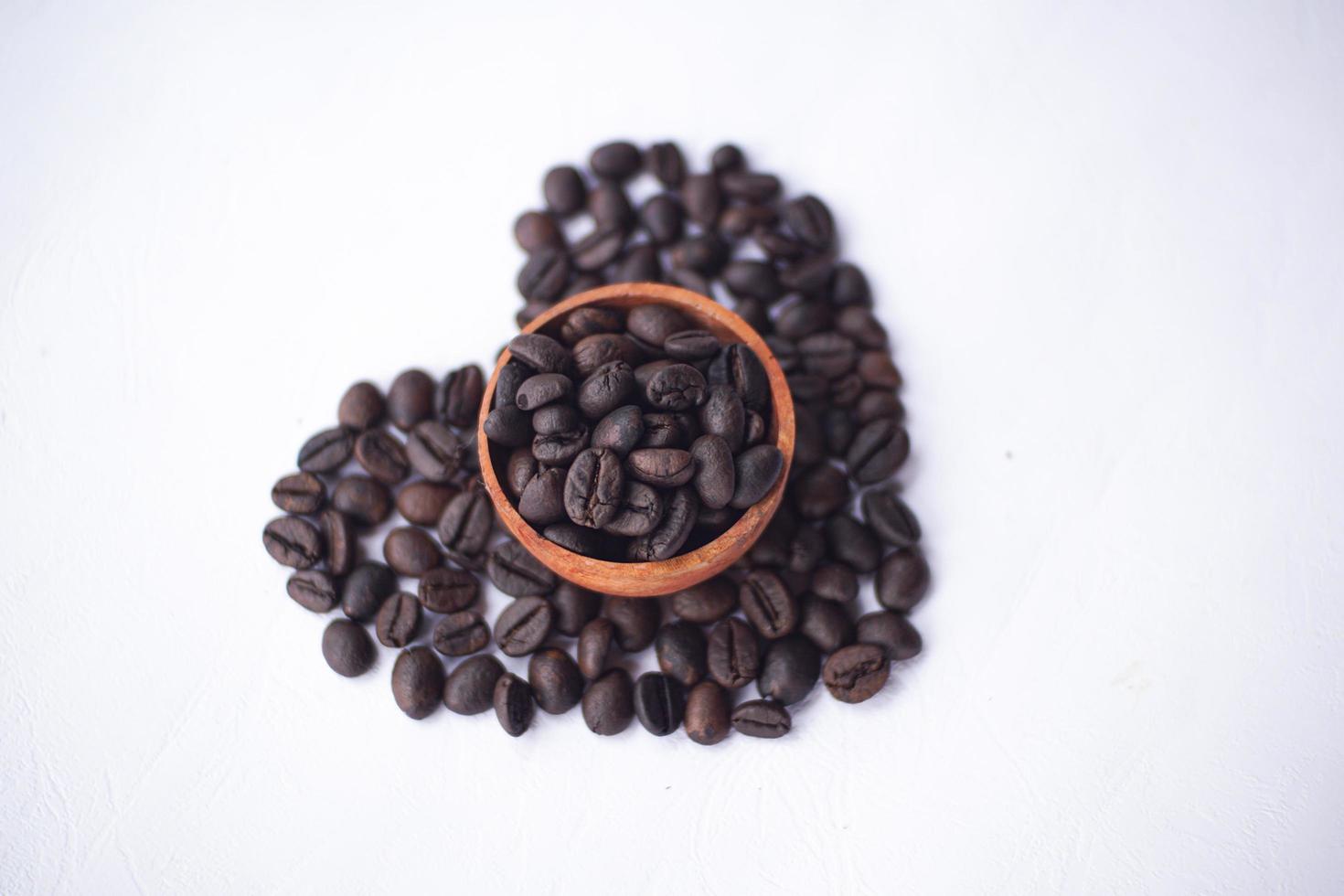 coffee beans on a wooden bowl with love shape photo
