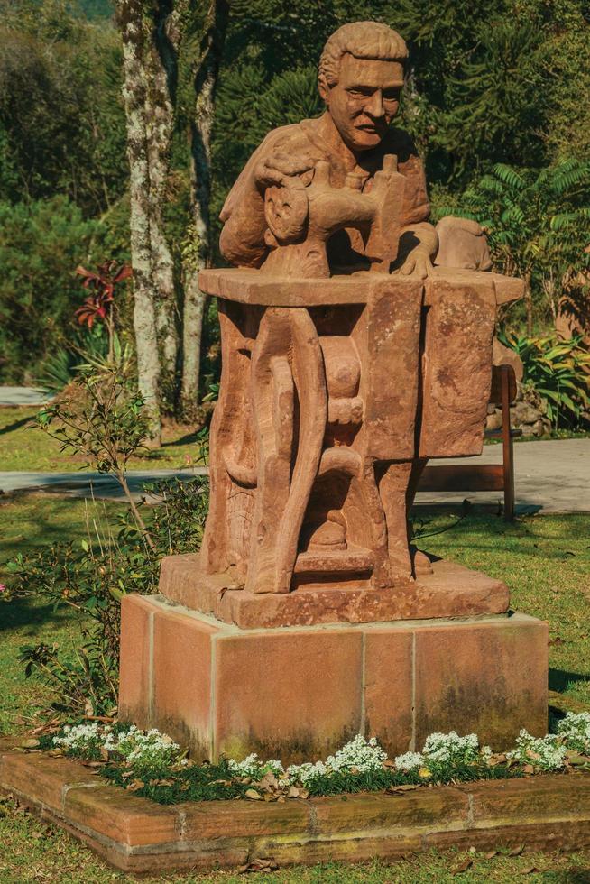 Nova Petropolis, Brazil - July 20, 2019. Sandstone sculpture of a tailor in a garden at the Sculpture Park Stones of Silence near Nova Petropolis. A lovely rural town founded by German immigrants. photo