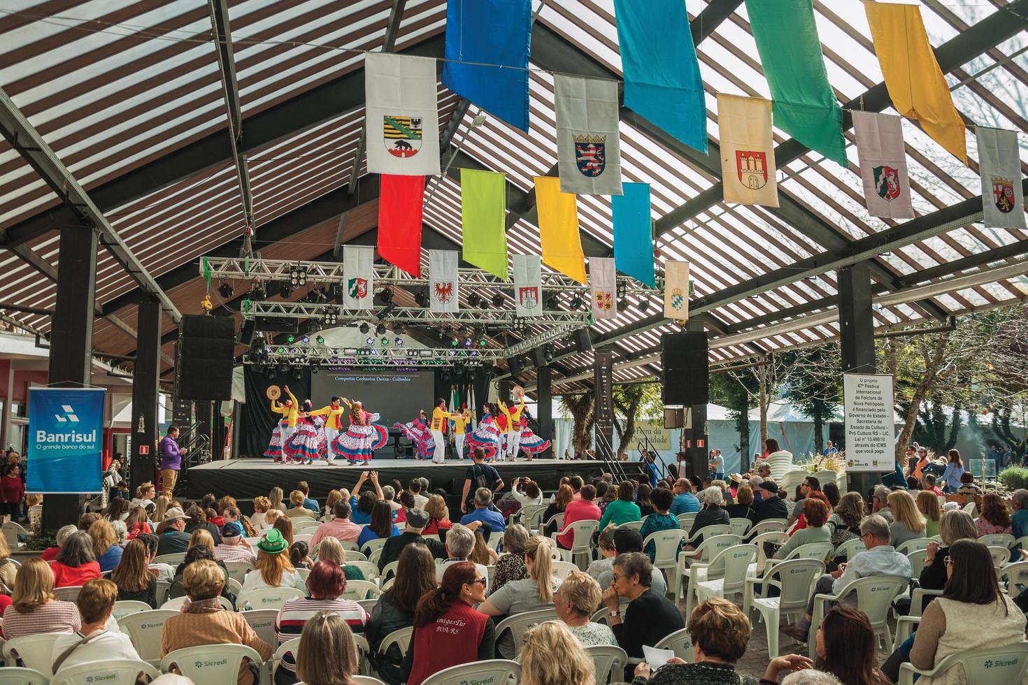 Nova Petropolis, Brazil - July 20, 2019. Colombian folk dancers doing a typical dance and audience on 47th International Folklore Festival of Nova Petropolis. A rural town founded by German immigrants photo