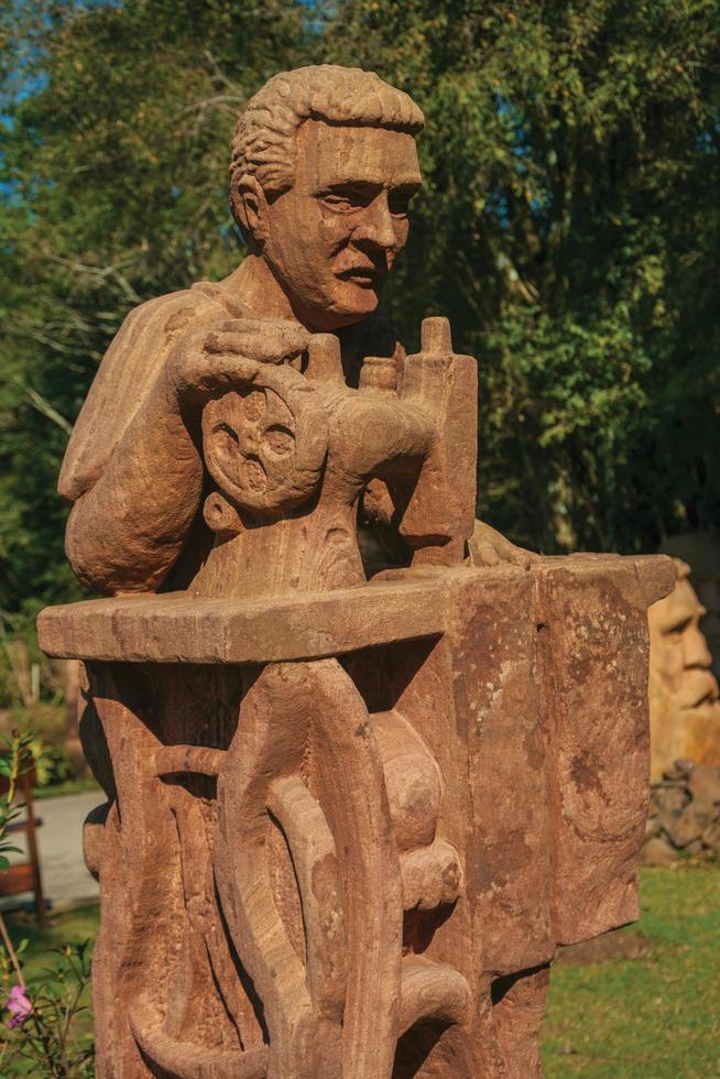 Nova Petropolis, Brazil - July 20, 2019. Sandstone sculpture of a tailor in a garden at the Sculpture Park Stones of Silence near Nova Petropolis. A lovely rural town founded by German immigrants. photo