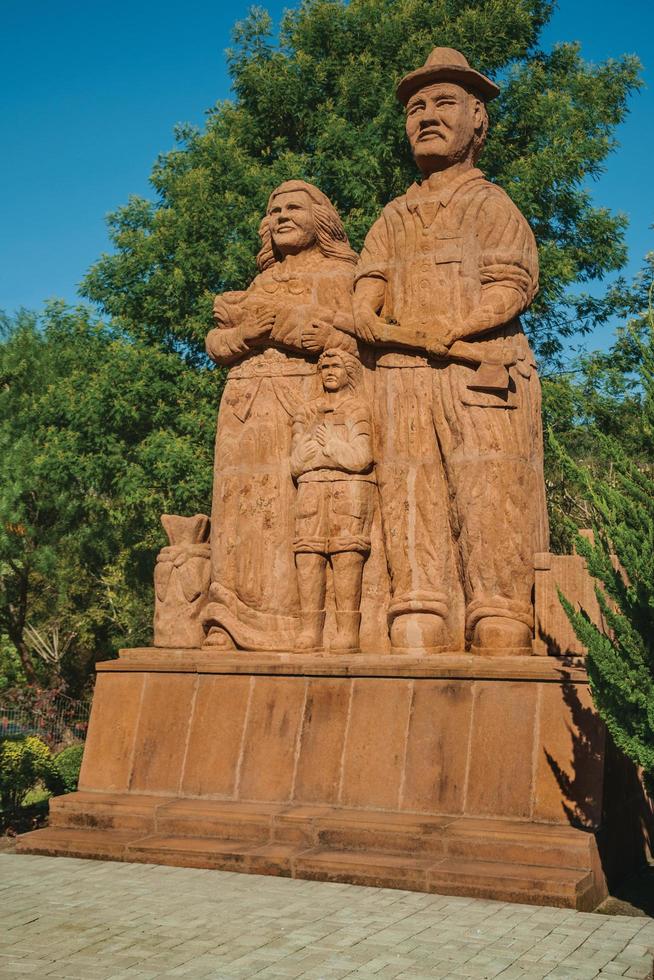 Nova Petropolis, Brazil - July 20, 2019. Sandstone sculpture of immigrant family in a garden at Sculpture Park Stones of Silence near Nova Petropolis. A lovely rural town founded by German immigrants. photo