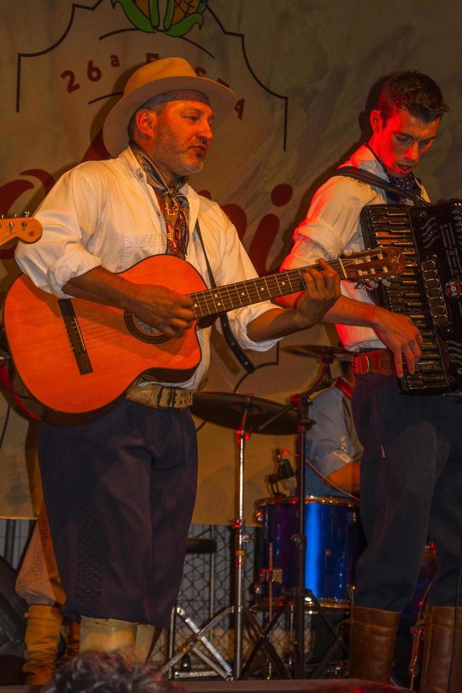 Canela, Brazil - July 21, 2019. Musicians wearing typical clothes performing traditional songs on stage of a folkloric festival in Canela. A charming small town very popular by its ecotourism. photo