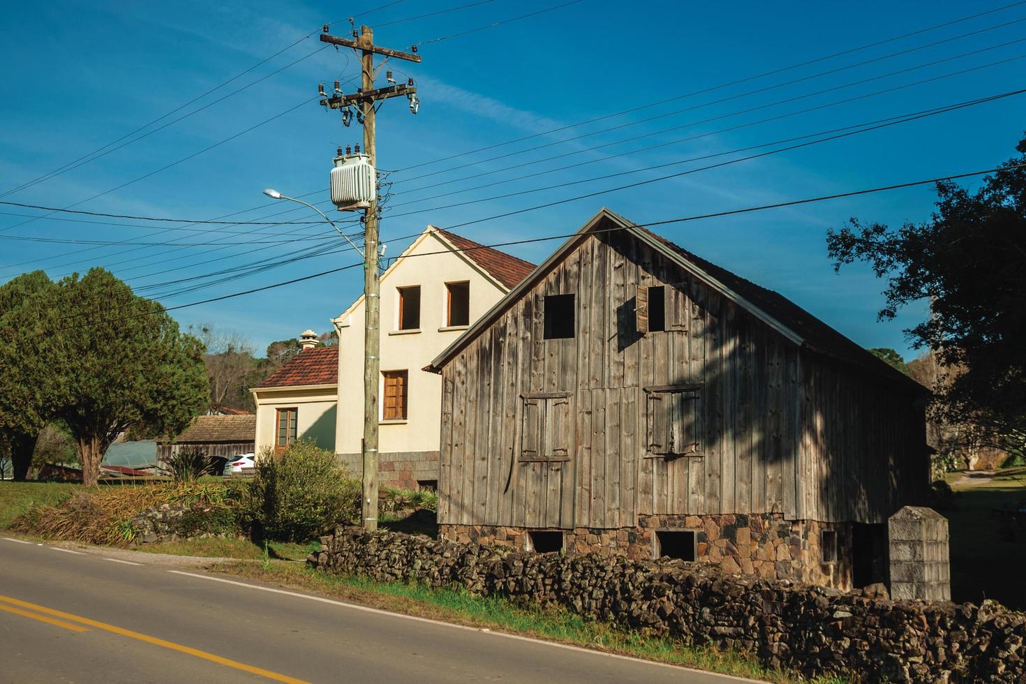 Bento Goncalves, Brazil - July 11, 2019. Old rural house made of wood in a traditional Italian-influenced style, in a countryside road near Bento Goncalves. photo