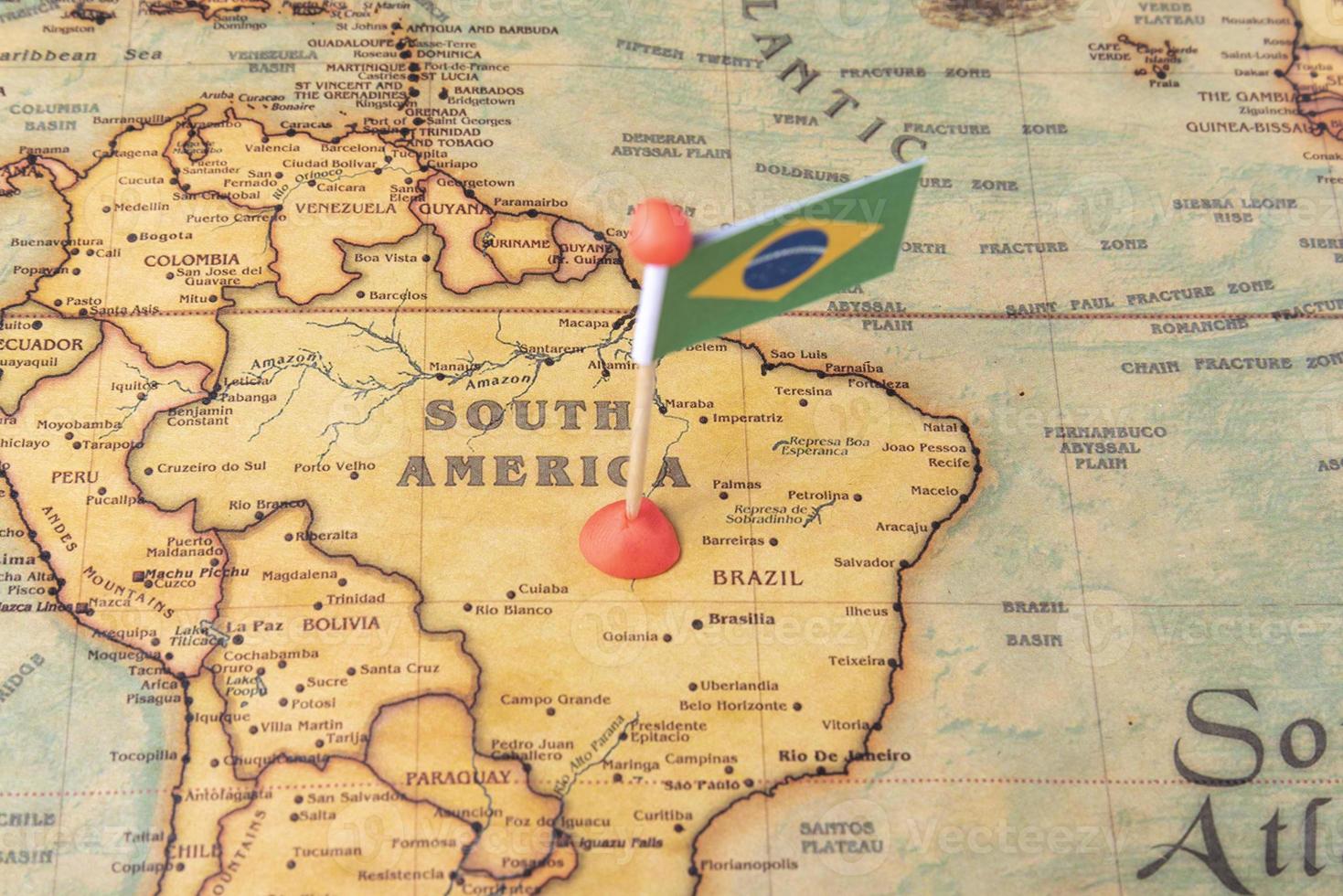 Brazil is marked with a flag on the map. Flag of Brazil on the world map. photo