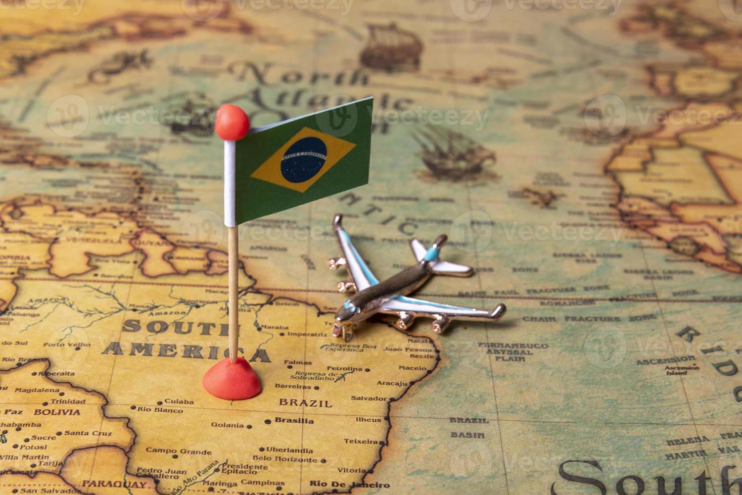 The flag of Brazil and the plane on the world map. photo