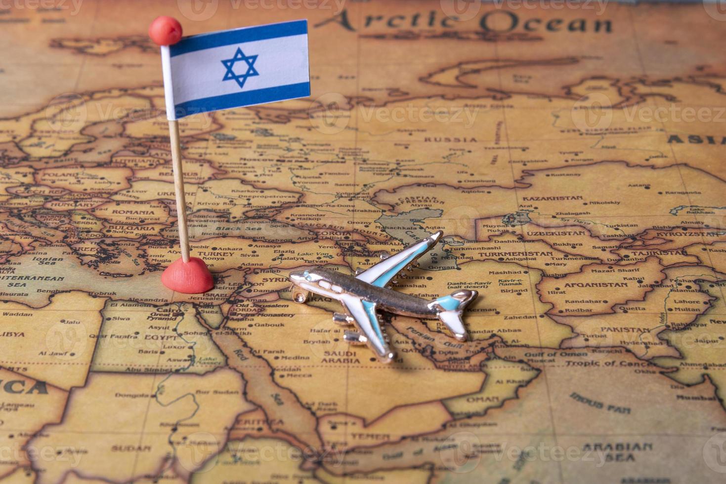 The flag of Israel and the plane on the world map. photo