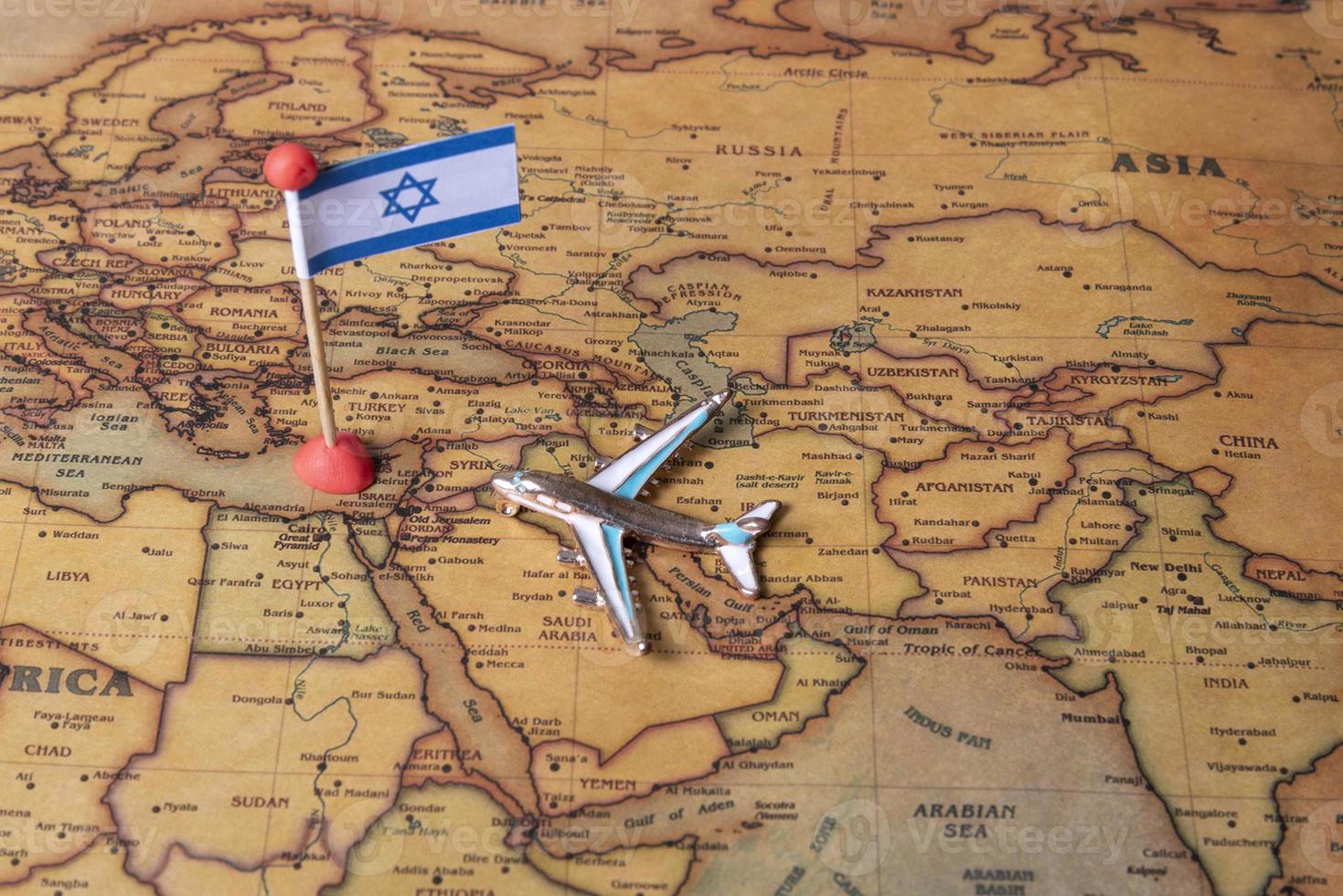 The flag of Israel and the plane on the world map. photo